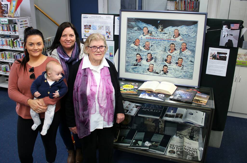 Items from the late David Newell's collection on display at Gunnedah Shire Library. Pictured are Mr Newell's niece Gabrielle Wales with her son Wren, his sister Jennifer Werner, and his mother Rose Newell. 