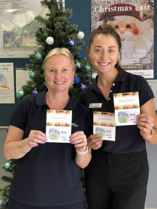 Gunnedah Shire Council's Jocelyn Porter and Sophie Priestley with Gunny Money gift cards. Photo: supplied