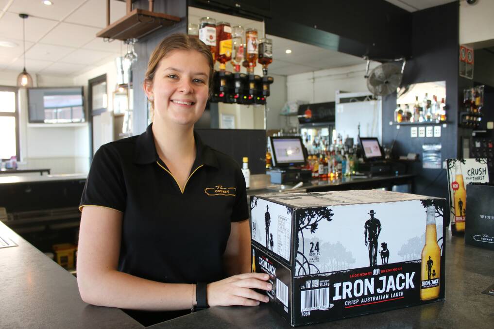 Amy Moore with a carton of Iron Jack at The Courthouse Hotel in Gunnedah. The Courthouse is one of Gunnedah's pubs and clubs involved in the Beers for the Bush drought campaign. Photo: Vanessa Höhnke