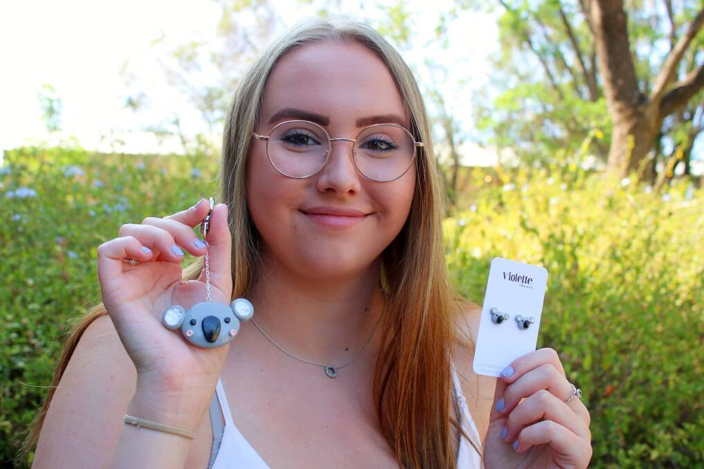 Maddy Taylor with her handmade koala key chains and earrings. Proceeds from the sales are going to WIRES.