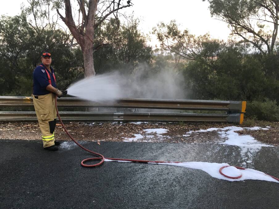 Neal Swain uses bushfire foam to put out the grass fire at Porcupine on Tuesday morning. Photo: Fire and Rescue NSW Gunnedah