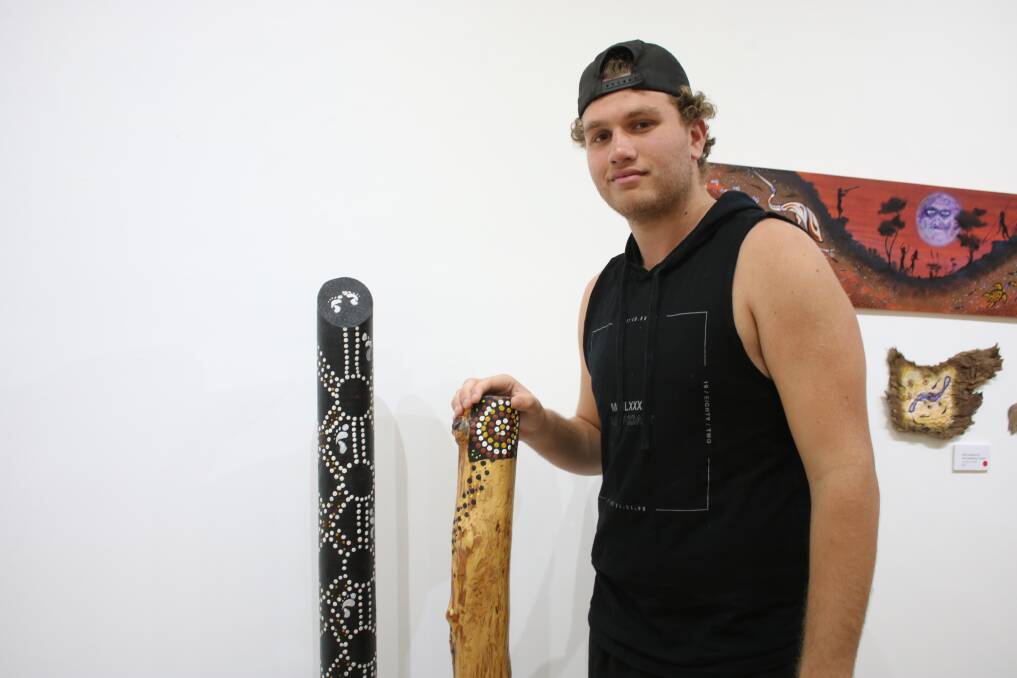 Gunnedah High School's Ryan Kelly-Payne with the totem pole and didgeridoo he entered in the exhibition.