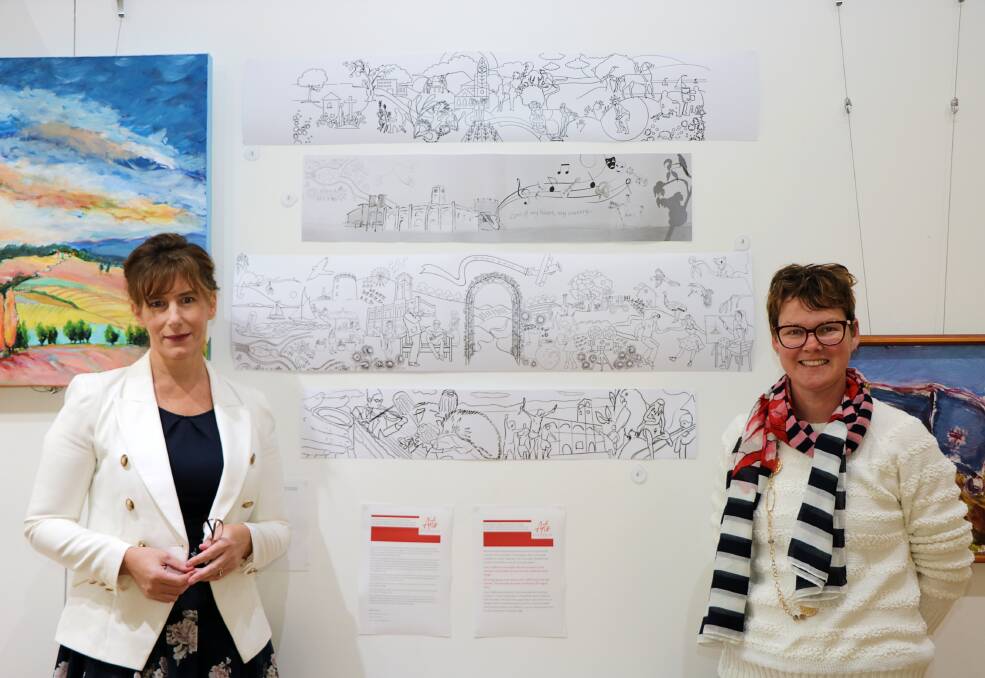 Arts Gunnedah president Michelle Wellham and member Jade Punch with the four mural designs, which can can be voted on by the public.