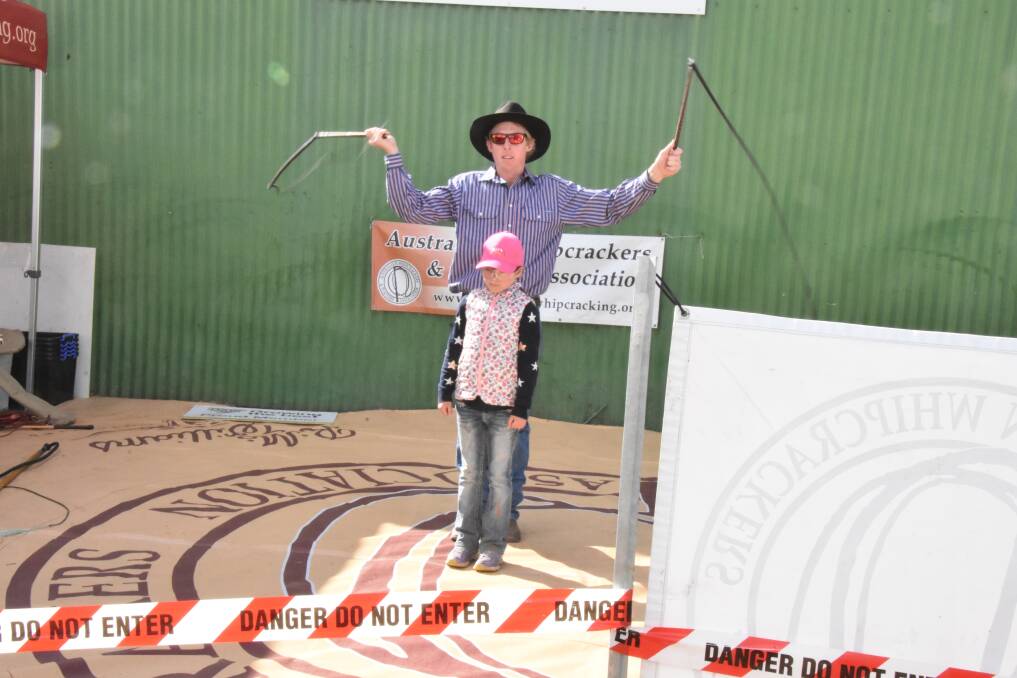 Daniel Wicks draws in onlooker Matilda Marshall for a whip cracking demonstration at AgQuip. 