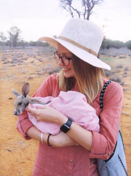 Medical student Sarah Clark meets joy Cindy-Lou at the Alice Springs Kangaroo Sanctuary.