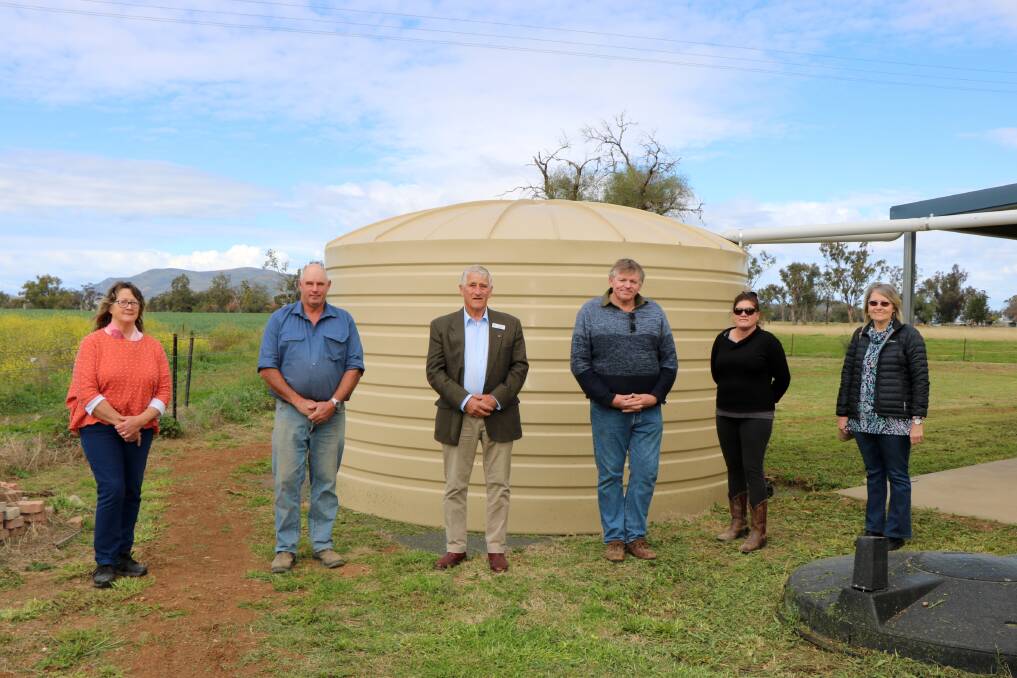 Gunnedah shire deputy mayor Rob Hooke, centre, with Kelvin Hall committee members Sue Cox, Brett Waters, Michael Roberts, Ingrid Allen and Denise Roberts and the new tank purchased with funds from the Drought Communities Program.