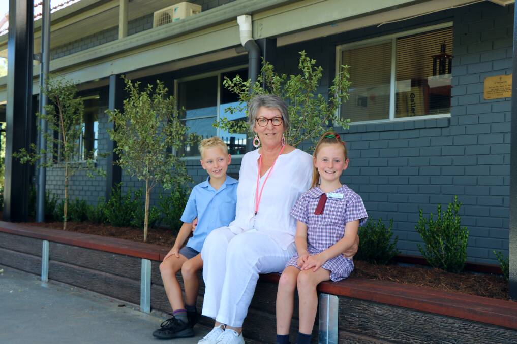 St Xavier's Primary School principal Jen Honner with twins Elijah and Skylah Guinery in the new entrance way.