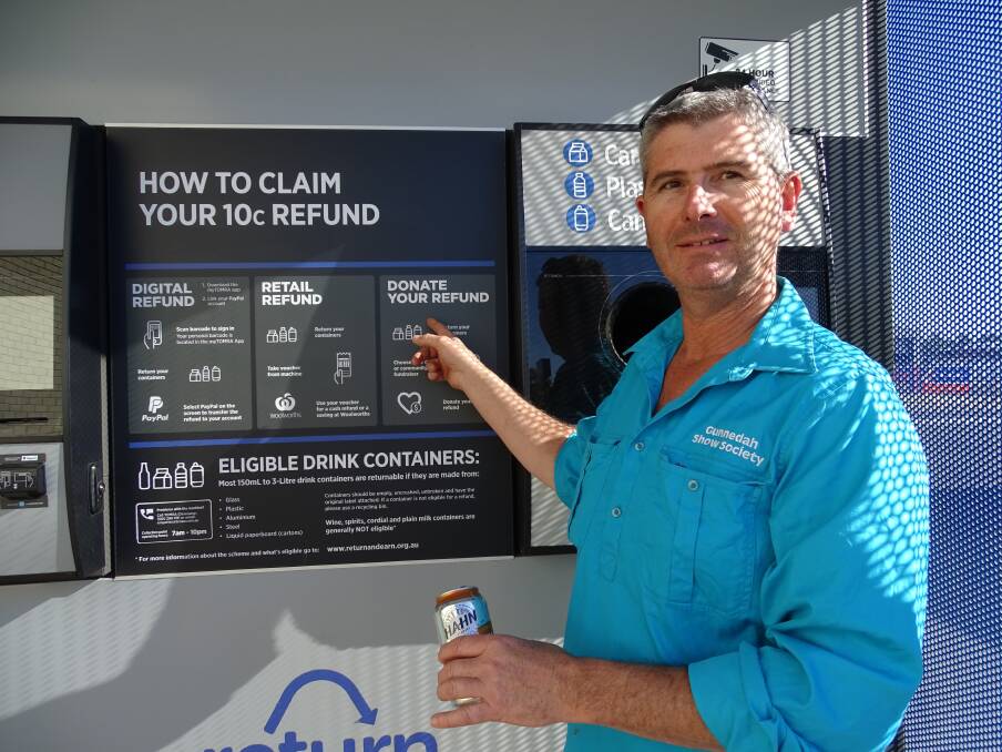Gunnedah Show Society's George Truman at the Return and Earn vending machine at Woolworths. Photo: Supplied