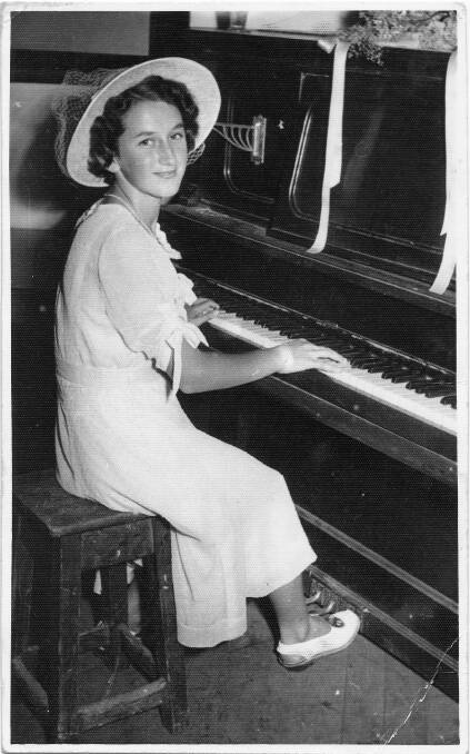 Doreen playing the piano at a young age.