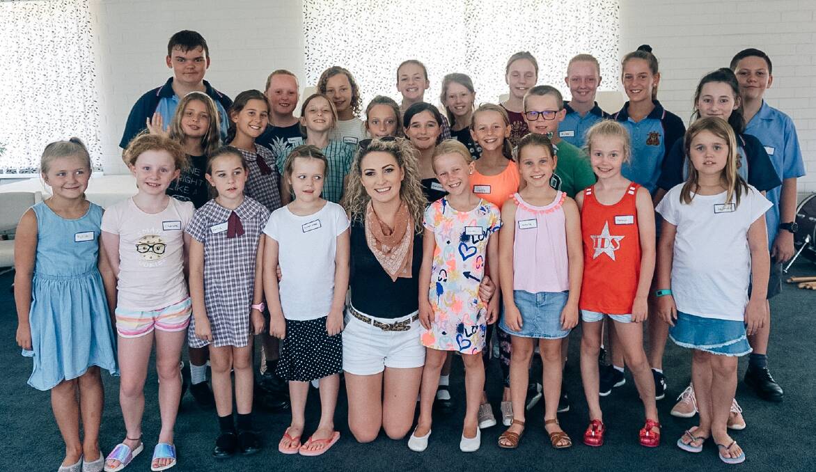 NEXT GENERATION: Katrina Burgoyne (centre) with Gunnedah youth who will lend their talents to the community concert on Saturday night.