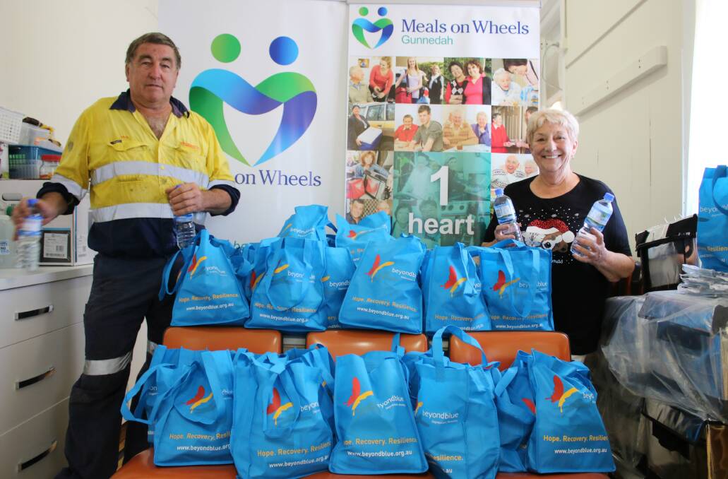 FESTIVE GIFT: Campdraft Club president Mick McLoughlin and Meals on Wheels president Colleen Fuller with some of the Christmas hampers that will be delivered to clients. Photo: Vanessa Höhnke