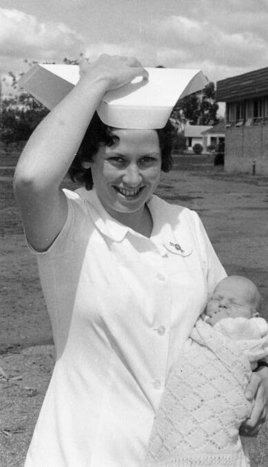 Chris Mirow carrying baby Rodney Jones out to his parents' car on September 26, 1975. She delivered Rodney in her first year at Gunnedah District Hospital. 