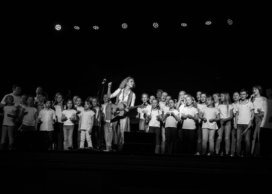 COMING TOGETHER: Singer-songwriter Katrina Burgoyne performs with Gunnedah youth on Saturday night. Photo: Di Stacey