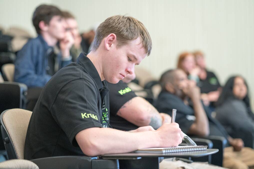 Deagan Marchant makes notes during a lecture at UNE. Photo: UNE