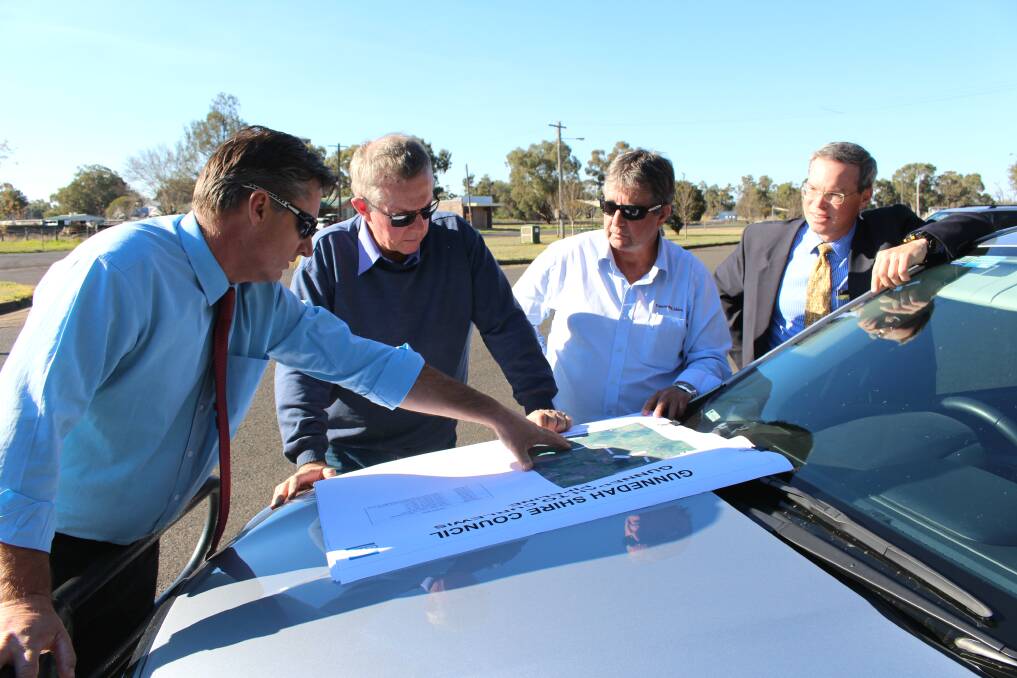 Gunnedah Shire mayor Jamie Chaffey, Member for Parkes Mark Coulton and Gunnedah Shire Council's water services manager Kevin Sheridan, and acting director of infrastructure services, Edward Paas look at pipeline plans in August. Photo: Simon Chamberlain