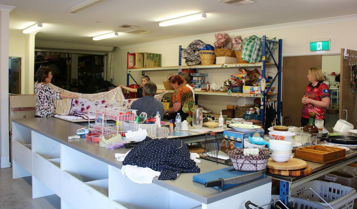 Volunteers sorting through donations out the back of the Salvos store.
