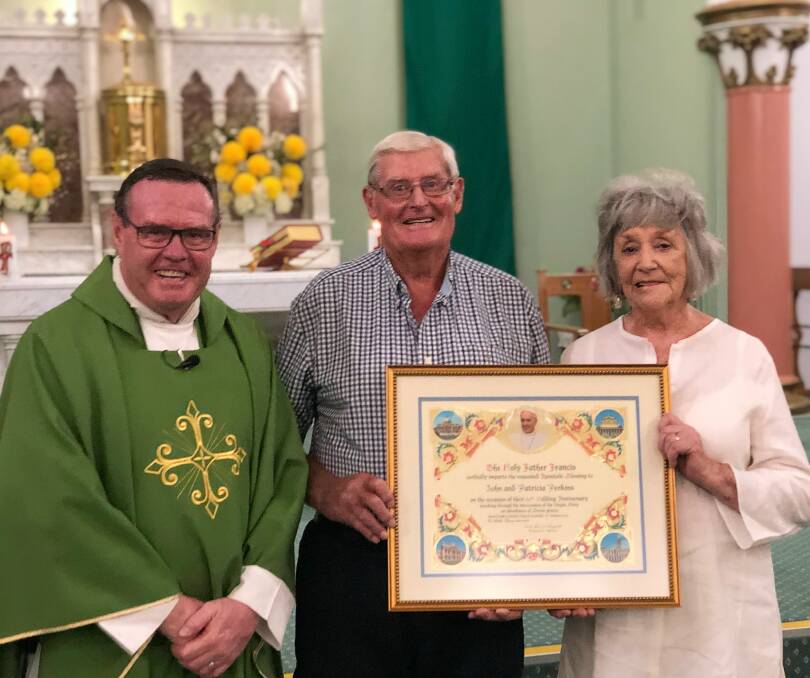 John and Pat Perkins with parish priest Fr John McHugh who presented the Apostolic Blessing from Pope Francis. Photo: Maryanne Perkins