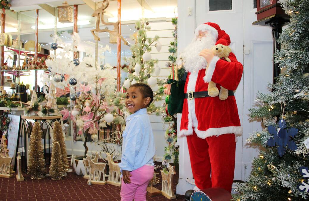 Three-year-old Suzette Gembu's excitement was catching when she explored the Christmas shop on Thursday. Photo: Vanessa Hohnke