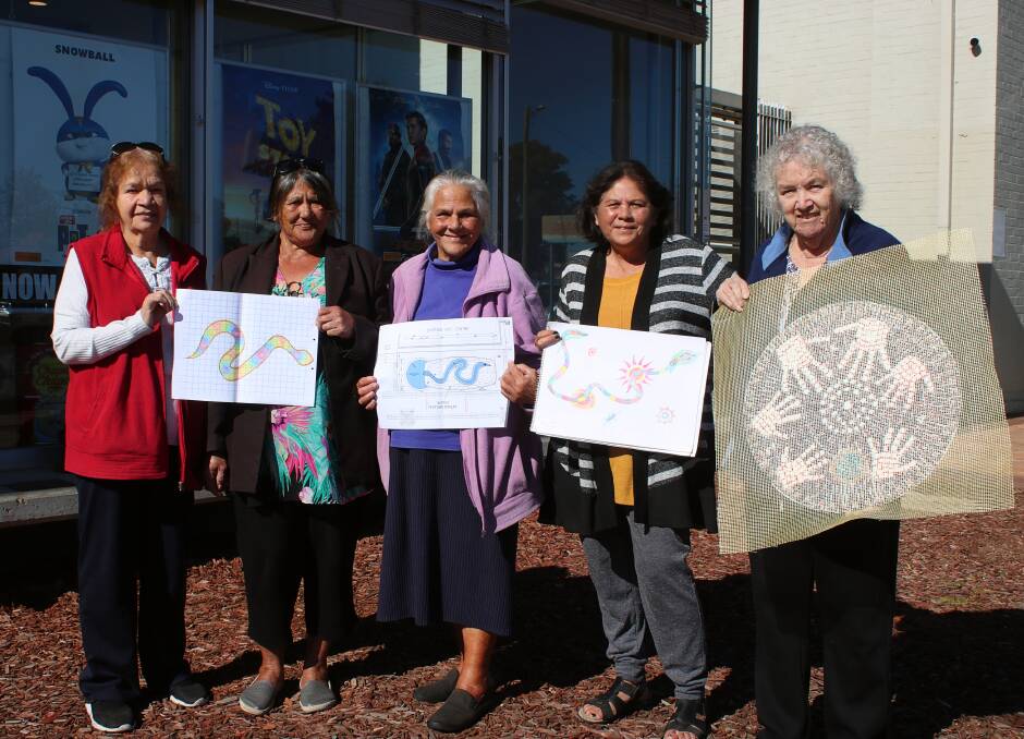 Janet Wanless, Rita Long, Shirley Long, Gloria Foley and June Cox with original drawings and one of mosaic tiles.