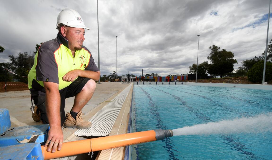 Hines Constructions' Mark Damon filling the pool up ahead of the re-opening late last year. Photo: Gareth Gardner