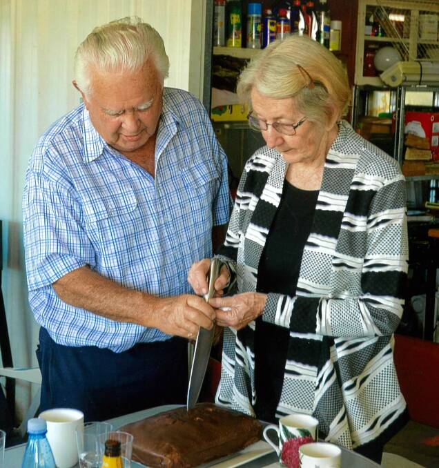 Max and Doreen Small cut their anniversary cake. Photo: Ian Austin