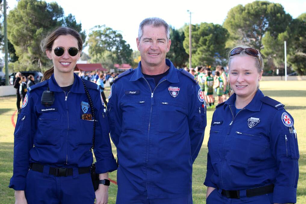 Trainee paramedic Maddi Lisle and paramedics Peter Patterson and Danielle Colver at an Aussie Rules game on Thursday. The paramedics are well-trained in CPR, which is a key factor in patient care.