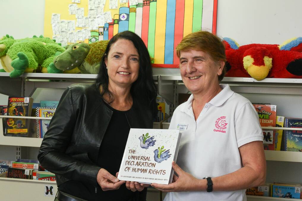 GIFT: National Rural Women's Coalition's Keli McDonald donates a child-friendly book on human rights to Gunnedah Shire Library. She is pictured with librarian Christiane Birkett. Photo: Di Stacey