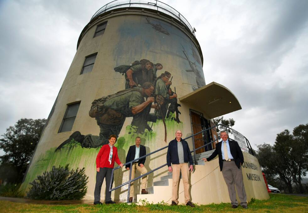 The murals will be coated to protect them from UV. Pictured are Gunnedah and District Historical Society's Marie Hobson, left, and Bob Leister, centre, with Gunnedah shire mayor Jamie Chaffey and Parkes MP Mark Coulton on Friday. Photos: Gareth Gardner