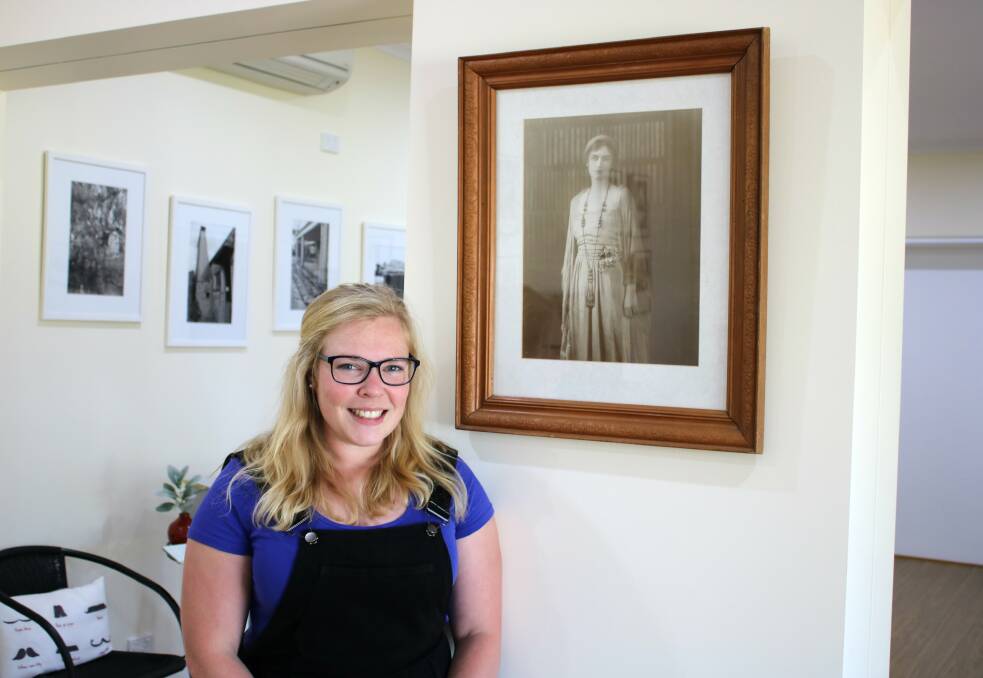 Ruth Macaulay, is wrapping-up her time as the Dorothea Mackellar Poetry Awards project officer. She is pictured her with a photo of the late poet Dorothea Mackellar. 