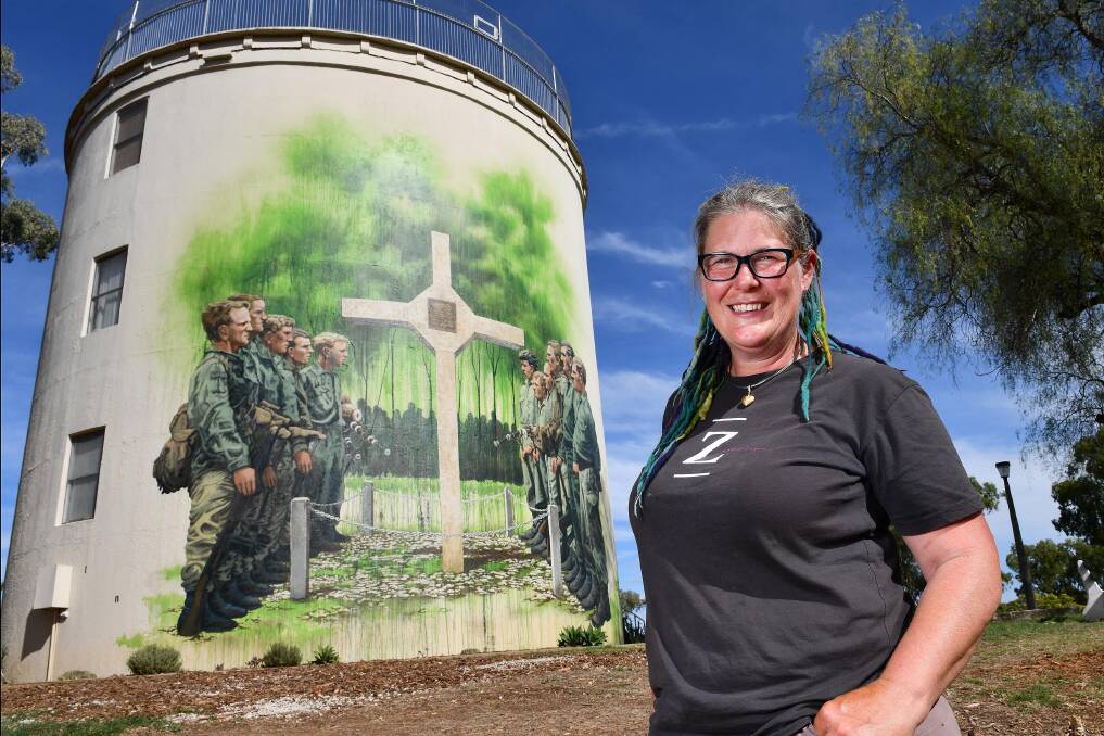 WAR MEMORIAL: Artist Jenny McCracken with one of her Vietnam War murals, which have been shortlisted in the Australian Street Art Awards. Photo: Paul Mathews