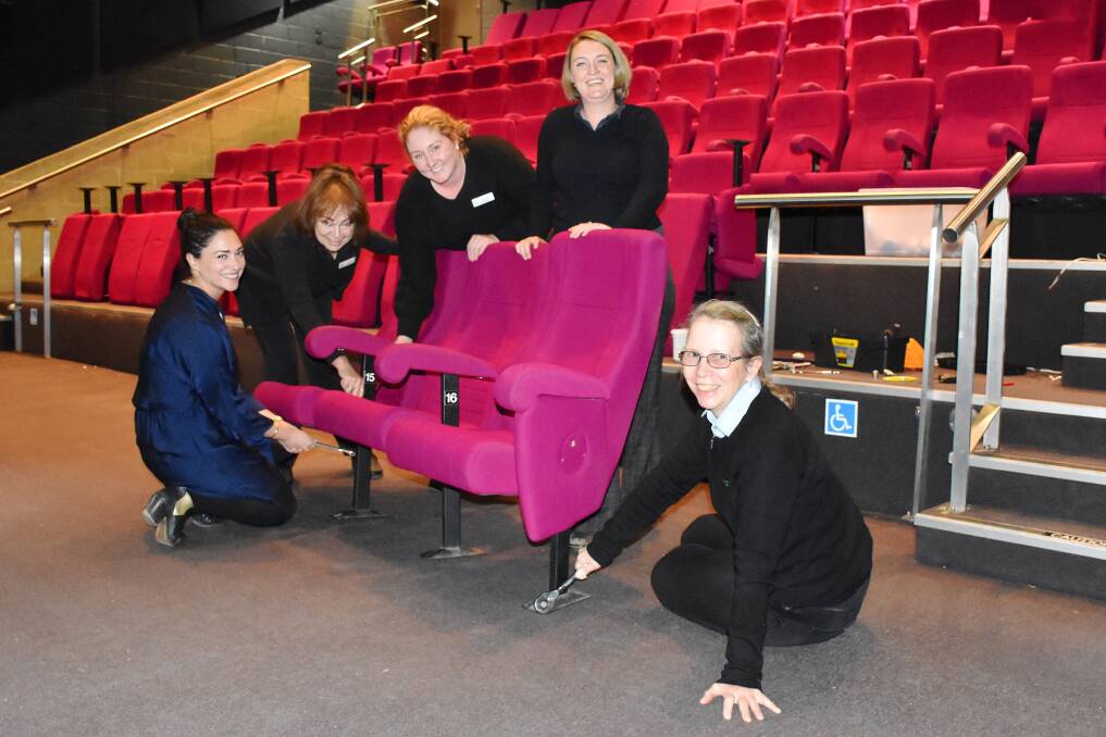 Gunnedah Shire Council staff Jacinta Cipolla, Kim Howard, Mikaela Meyers, Lauren Mackley and Annette Gardner with the original theatre seats before they were replaced. Photo: supplied