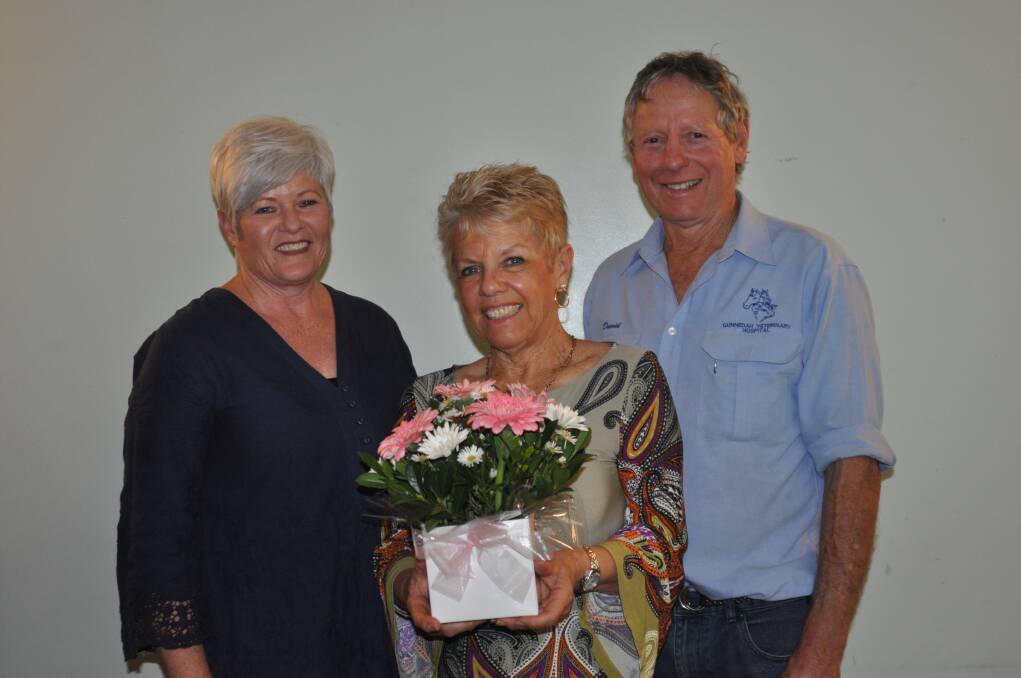 Sue Braby presenting flowers to guests speakers Margaret and David Amos.