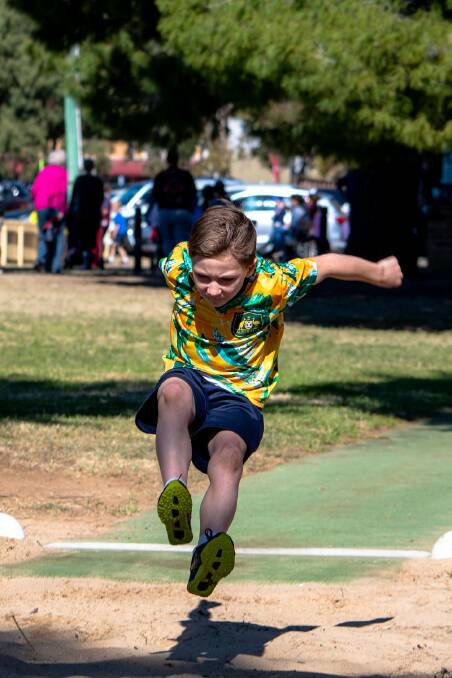Cleal Bender about to land in long jump at St Xavier's athletics carnival. Photo: Haley Hausfeld