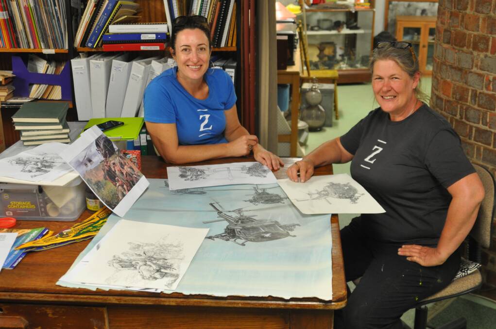 Zest Events manager Andi Mether and artist Jenny McCracken with drawings for the mural concept at the Gunnedah Water Tower Museum. Photo: Marie Hobson