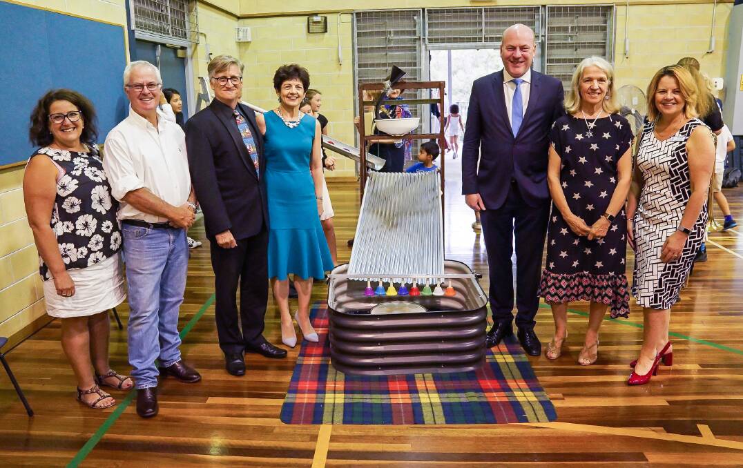Andrew Frend (second from left) at the Red Earth Christmas Concert with friend Jenny, youth orchestra conductor Mark Brown, Lane Cove mayor Pam Palmer, MP Trent Zimmerman, youth orchestra president Lyndall McNally and Hunter Hills High School teacher Jenny Sibley. They are pictured with the innovative "rain machine". Photo: Janet Merewether