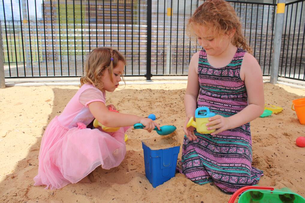 Gunnedah kids Willow-Roze Leveni and Shanelle Ryan in the sandpit at GS Kidd Memorial School in the Christmas holidays. Photo: Vanessa Höhnke