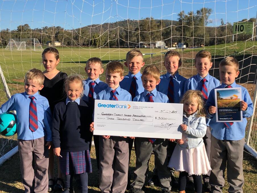 Gunnedah and District Soccer Association players with the Greater Bank cheque. Photo: supplied