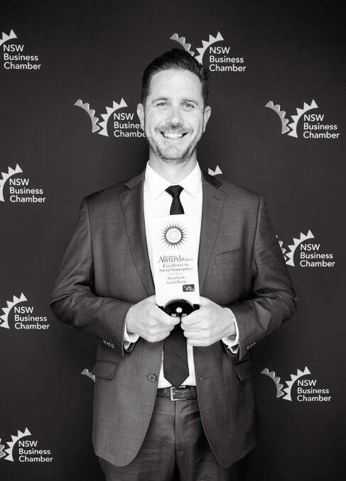 BACKING IT UP: BackTrack's Marcus Watson claims a top NSW business awards on behalf of the Armidale organisation. Photo: Supplied