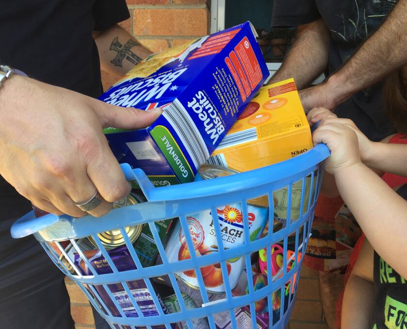 A local family keen to receive a food hamper from Gunnedah Salvation Army. Photo: Gaye Day