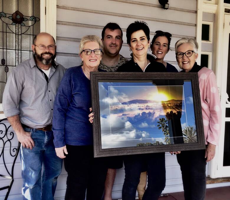 Blackjack Camera Club's Stuart Dolbel, Pat Timmins, Anthony Hennessy, Kellee Clark, Erin Formann and Marg Carr with one of the photographs that will go on display for the exhibition.