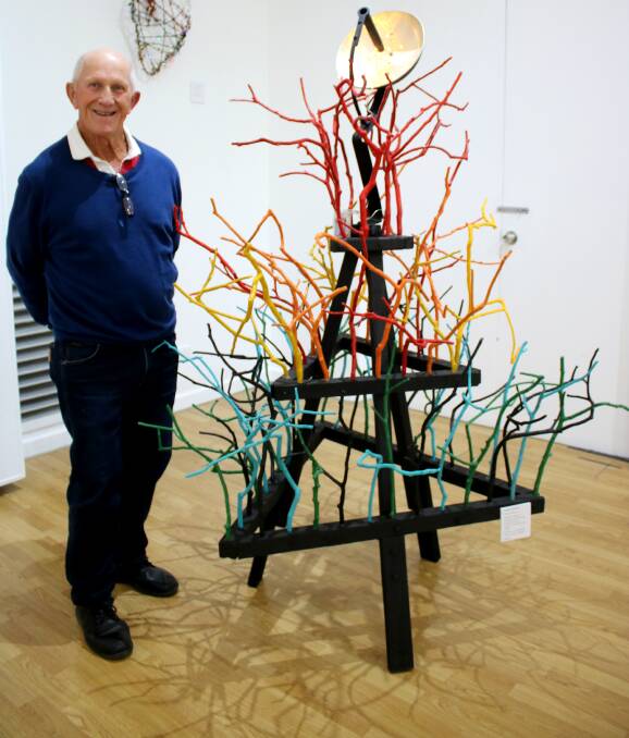 Warren Barwick made a colourful work in 2017 using tree branches, a wok lid, spark plug spanner, timber and LED lights.