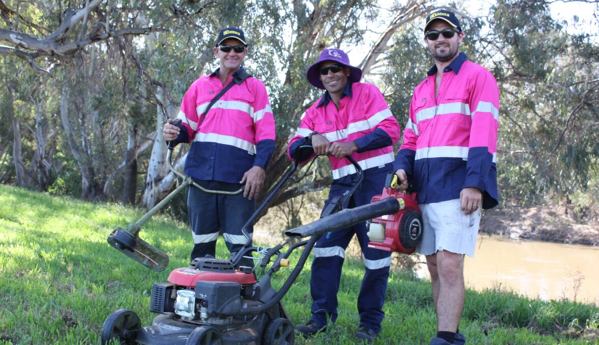 THINK PINK: Gunnedah Grow and Mow team Darrin Cameron, David Murray and Michael Cooke are standouts in their pink hi-vis shirts for Breast Cancer Awareness Month.