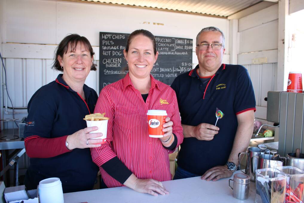 Volunteers Alison Kelly, Lisa Roach and Mike Tighe at the Gunnedah Shire Band's stall at AgQuip.