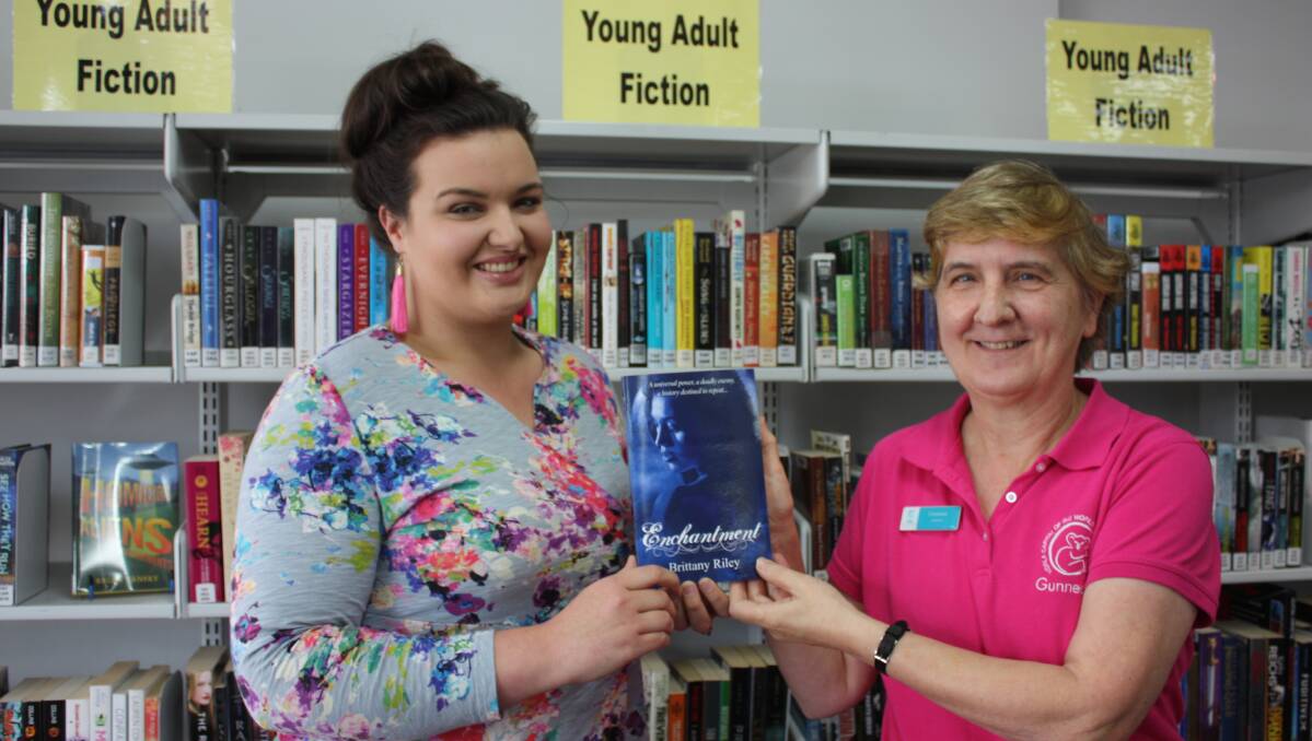 NOVEL ACHIEVEMENT: Brittany Riley's book, Enchantment, will find a home in the Gunnedah library. She is pictured with Christiane Birkett.