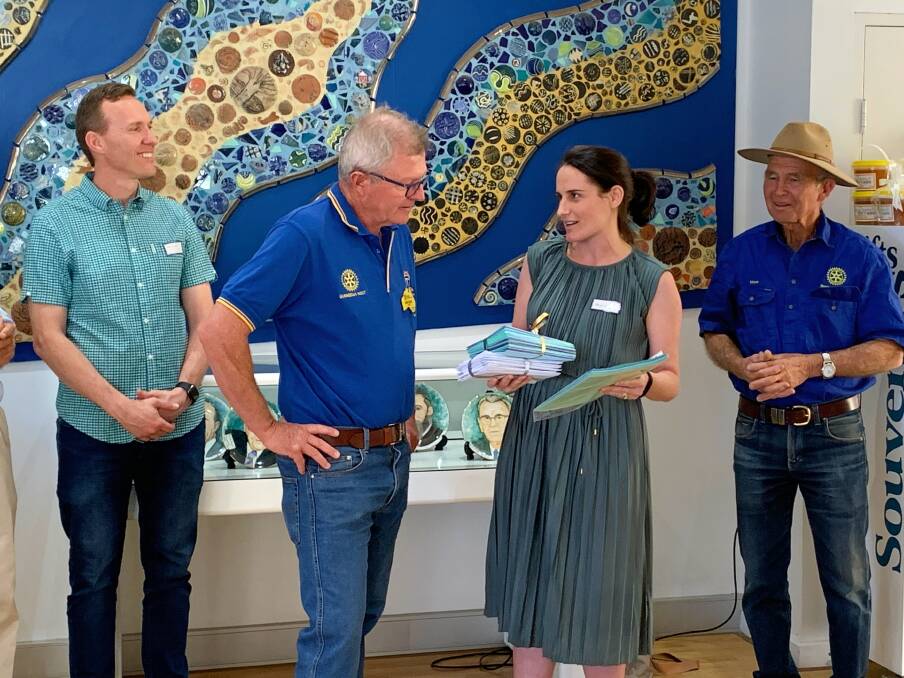 Lane Cove resident and ex-local Bronwyn Zbik (nee Deane) hands letters from students to Gunnedah Rotary West's Mark Kesby on a visit to the shire in November. Photo: supplied