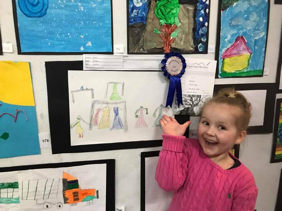 ALL SMILES: Horton Valley's Zara Kelly wins the Unwin Family Infants Painting First Prize for her entry Dress Shop. Judge Andrea Bruno said, "What girl does not like her dresses? What a lovely drawing, beautifully rendered coat hangers." Photo: Supplied