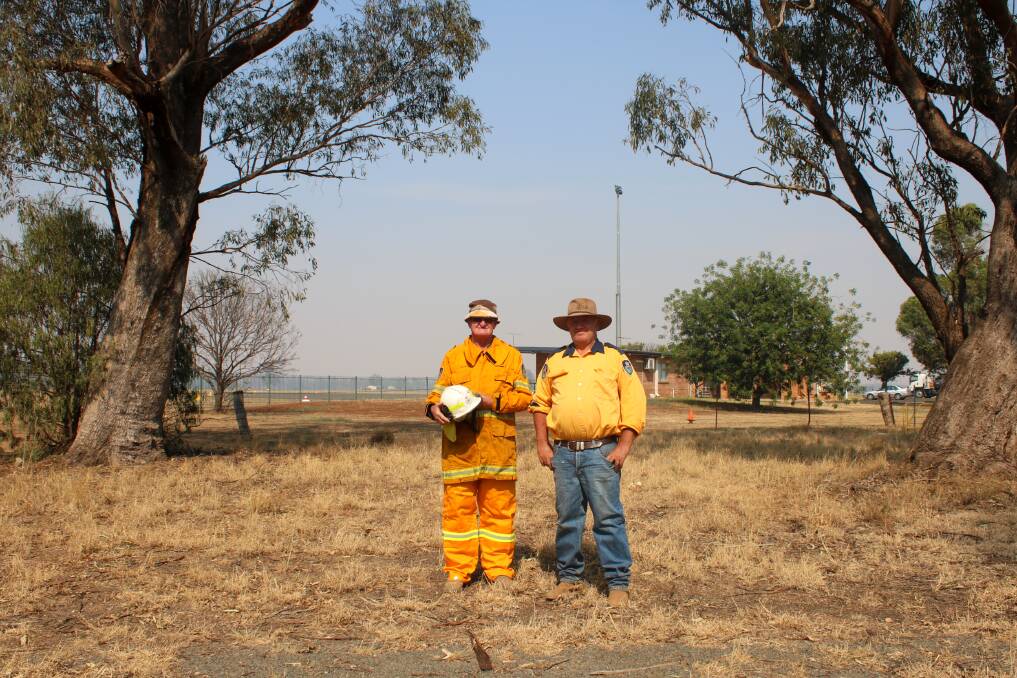 Gunnible RFS deputy captain Geoff Hood and Ken Moore in the Wean Road Reserve where the station will be build next to the airport.