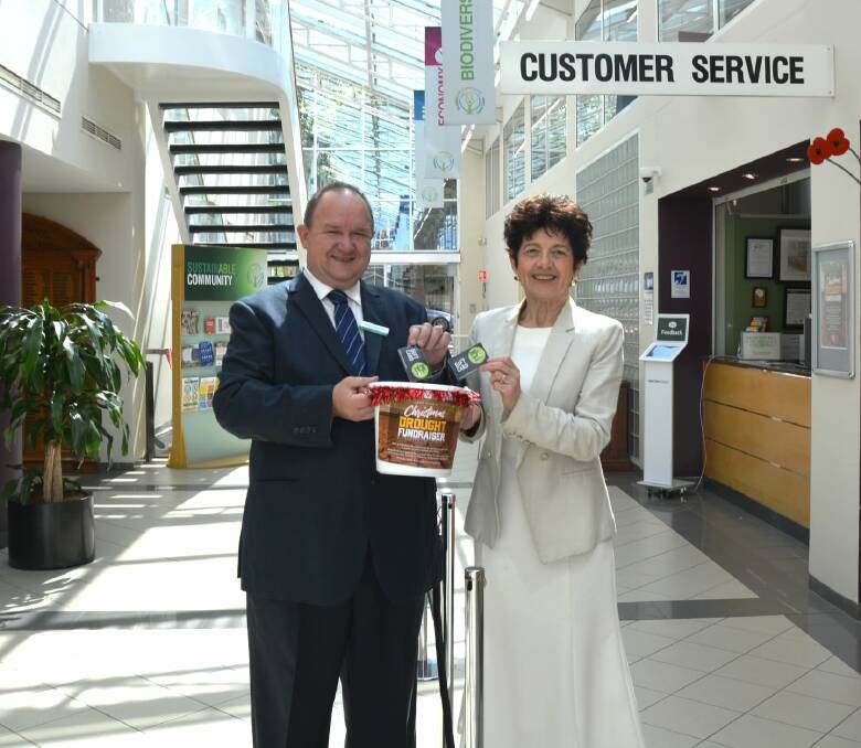 Lane Cove councillor Scott Bennison and mayor Pam Palmer dropping off their gift cards for residents of Gunnedah and Cobar at the council's civic centre. Photo: supplied