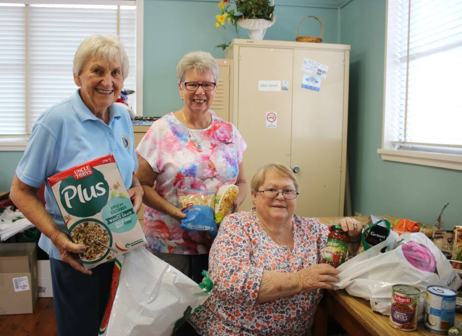 Gunnedah CWA members Coralie Howe, Kris Scott and Elaine Kennedy packing care hampers for farming families on Wednesday.