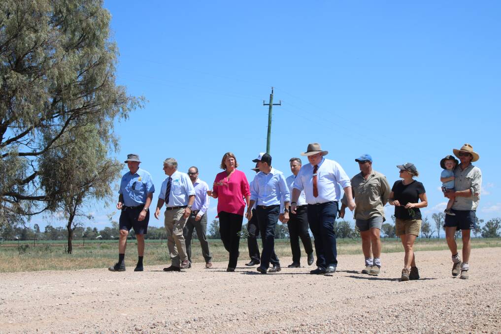 Mullaley residents, Gunnedah Shire Council staff, Minister for Roads, Maritime and Freight Melinda Pavey and Tamworth MP Kevin Anderson on the Grain Valley Road on Friday.